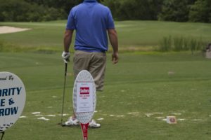 tmba golf tournament 2016 man looking down crouse southern auto sponsor priority title sponsor signs