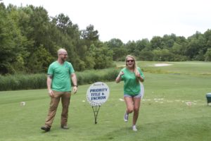 tmba golf tournament 2016 2 priority staff members laughing on green