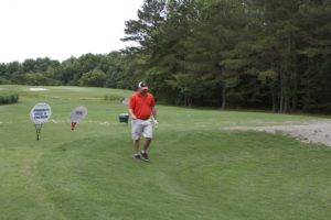 tmba golf tournament 2016 man walking on green orange shirt uva hat v3