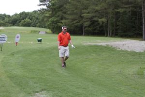 tmba golf tournament 2016 man walking on green orange shirt uva hat v2