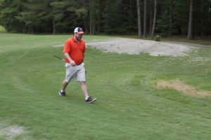 tmba golf tournament 2016 man walking on green orange shirt uva hat