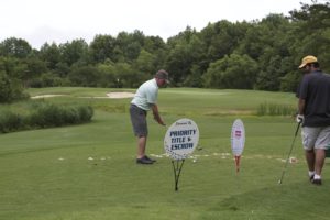 tmba golf tournament 2016 man preparing to drive ball