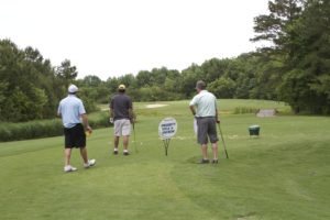 tmba golf tournament 2016 3 men looking down green clubs