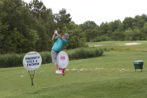 tmba golf tournament 2016 man swinging club priority title sign