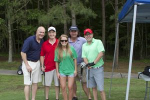tmba golf tournament 2016 group posing by tent trees